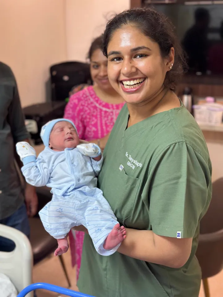 Dr. Tanya Gupta holding a newborn baby
